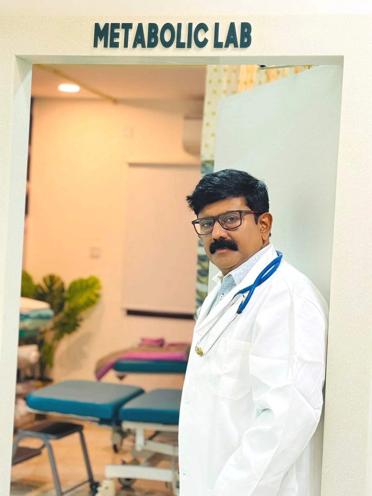 Dr Rajeswaran in a white coat at the metabolic lab